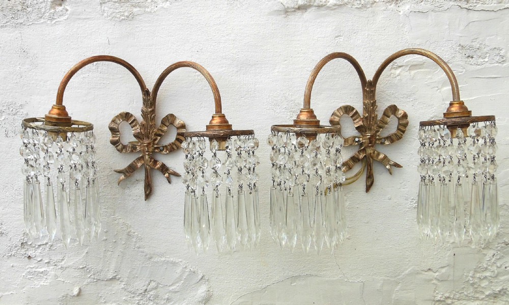 pair of wall lights with hanging lustres